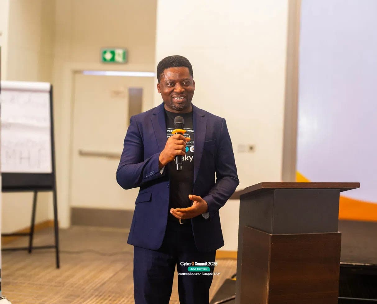 Segun Akande delivering a keynote with a microphone